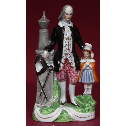 117 - A 19th Century Staffordshire figure of a man and child (possibly Paxton), 26cm high