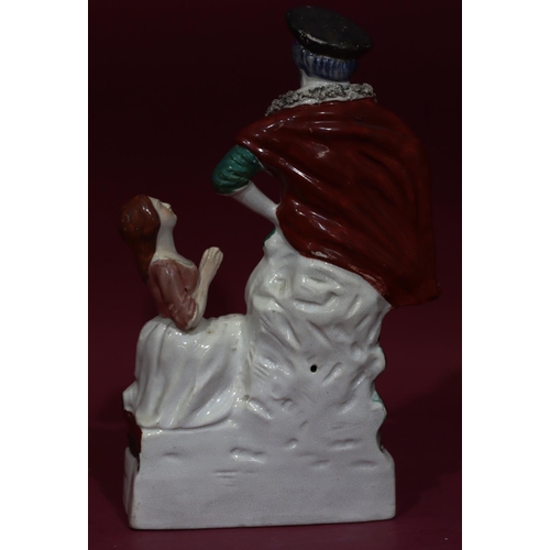118 - A 19th Century Staffordshire theatrical figure of Bluebeard and kneeling woman, 33cm high