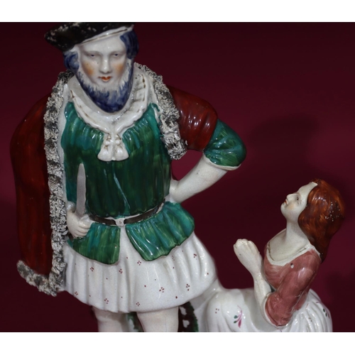 118 - A 19th Century Staffordshire theatrical figure of Bluebeard and kneeling woman, 33cm high