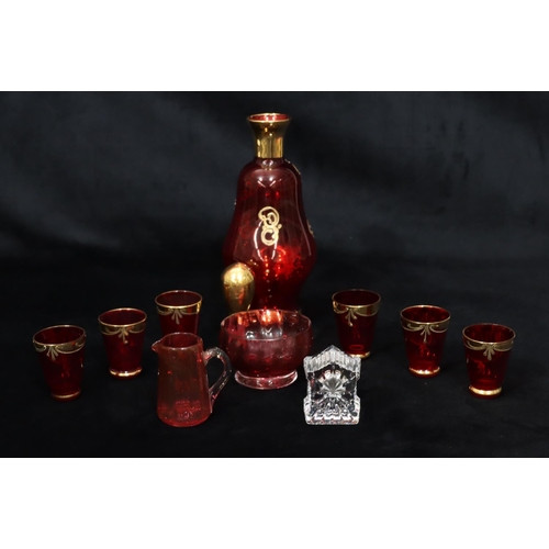 17 - A Continental ruby glass liqueur decanter with stopper and allover gilt and floral decoration, 6 mat... 