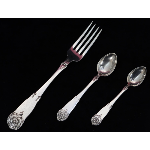 178 - A Danish 830 silver coloured metal spoon with hammered decoration and raised floral and leaf motif a... 