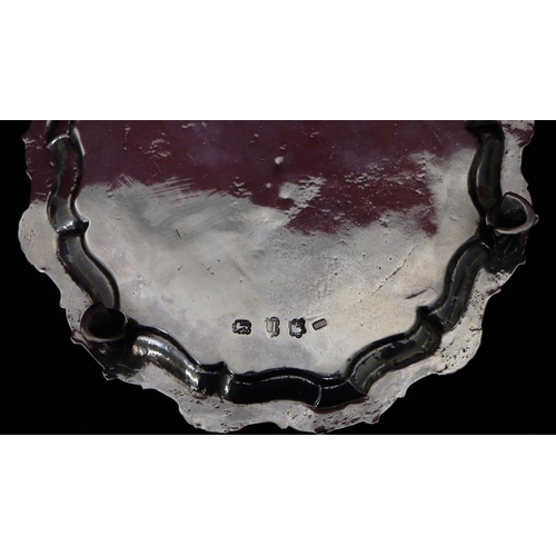 182 - A George II silver round pie crust card tray on 2 splayed hoof feet, with engraved crest, London 175... 