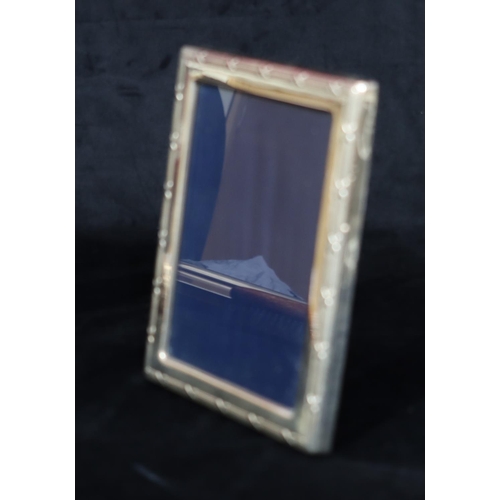 192 - A modern London silver mounted freestanding photograph frame with raised reeded and X shaped rim, bl... 