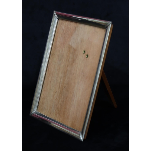 193 - A silver mounted plain freestanding photograph frame with wooden backing, 26.5cm x 21cm