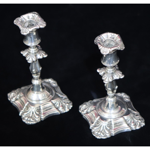 194 - A pair of Victorian silver small candlesticks with turned stems on square scallop shaped bases, Lond... 