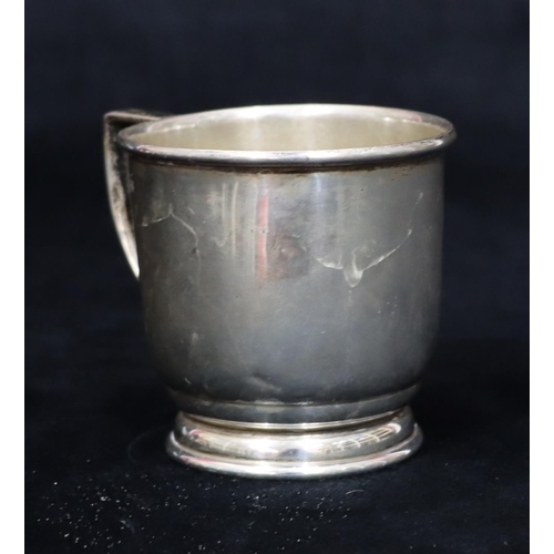 234 - A Birmingham plain silver christening mug on sweeping base (dented to 1 side), 2.1oz