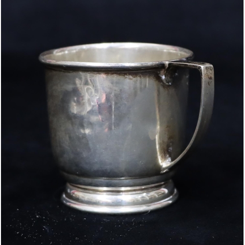 234 - A Birmingham plain silver christening mug on sweeping base (dented to 1 side), 2.1oz