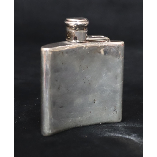 235 - A London small silver concaved shaped hip flask with screw hinged lid (dented but not split), 8cm hi... 