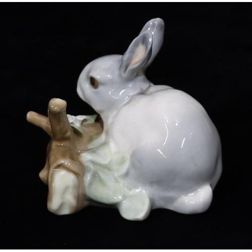 24 - A Lladro figure of a rabbit standing on a log, 8.5cm high