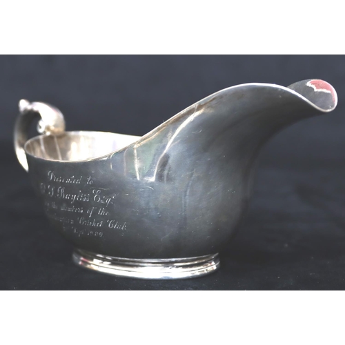 241 - A heavy Sheffield silver sauce boat with engraved presentation 