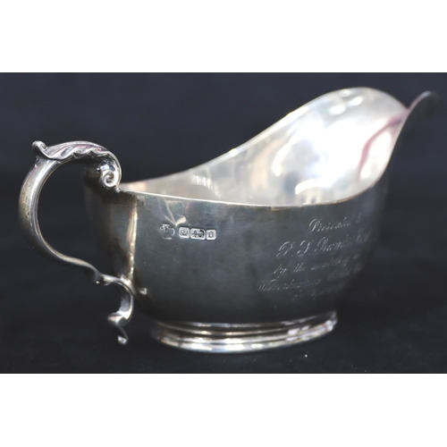 241 - A heavy Sheffield silver sauce boat with engraved presentation 