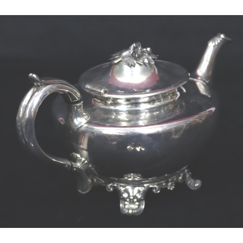 243 - An early Victorian silver round bulbous shaped teapot with scroll handle on splayed feet, London 184... 