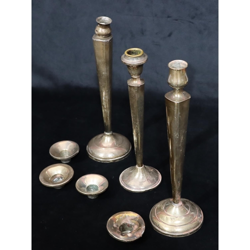 254 - 3 various similar Sterling silver candlesticks on tapering stems with round sweeping weighted bases ... 