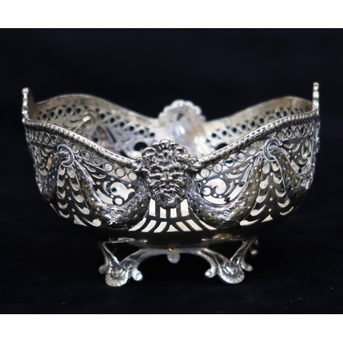 275 - An oval Chester silver sweetmeat dish with embossed and pierced mask head, swag and scroll decoratio... 