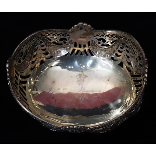 275 - An oval Chester silver sweetmeat dish with embossed and pierced mask head, swag and scroll decoratio... 