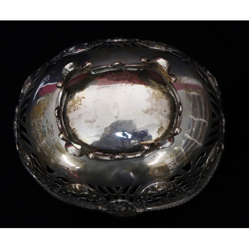 275 - An oval Chester silver sweetmeat dish with embossed and pierced mask head, swag and scroll decoratio... 