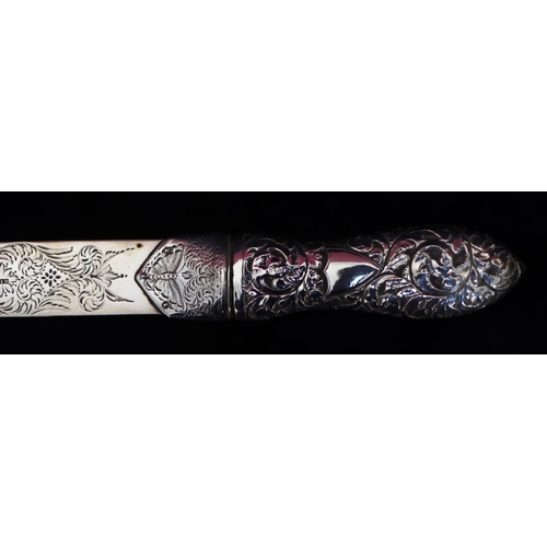 281 - A Victorian silver paper knife with embossed weighted handle and allover engraved floral, leaf and s... 