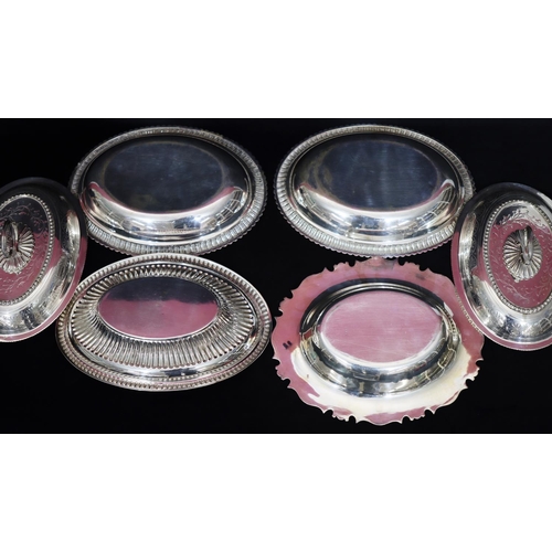 287 - A pair of silver plated oval entrée dishes with covers, embossed scallop shaped rim and allover engr... 