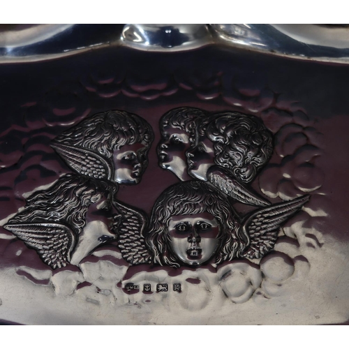 298 - An Edward VII silver rectangular scallop shaped dressing table tray with embossed cupid figurehead d... 