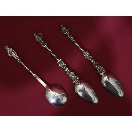 306 - A pair of Continental silver coloured metal Apostle teaspoons with twist stems, a similar smaller sp... 