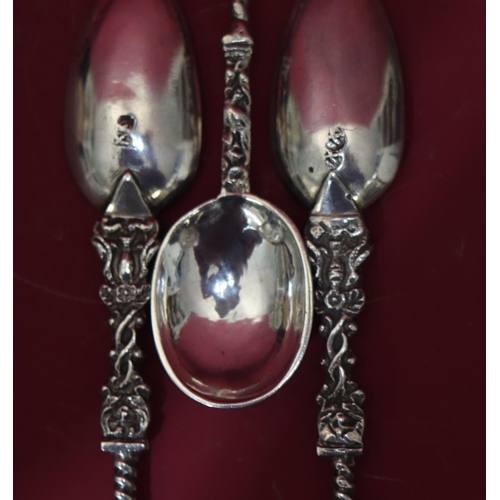 306 - A pair of Continental silver coloured metal Apostle teaspoons with twist stems, a similar smaller sp... 