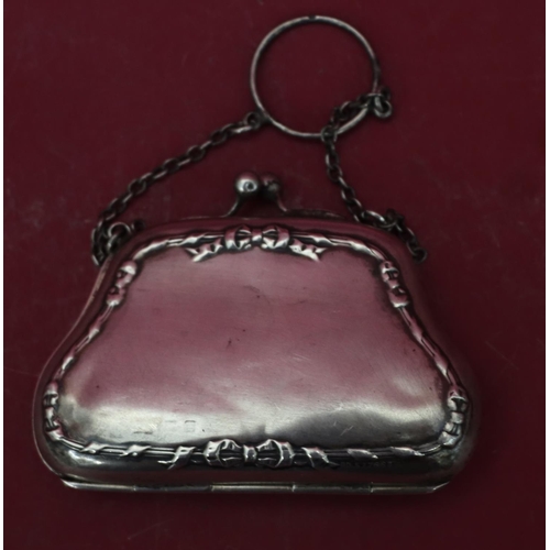 318 - A silver ladies' evening purse with chain, hinged centre enclosing red water silk interior (some den... 