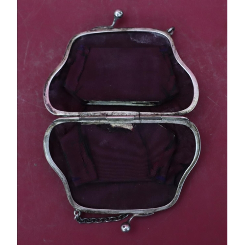 318 - A silver ladies' evening purse with chain, hinged centre enclosing red water silk interior (some den... 