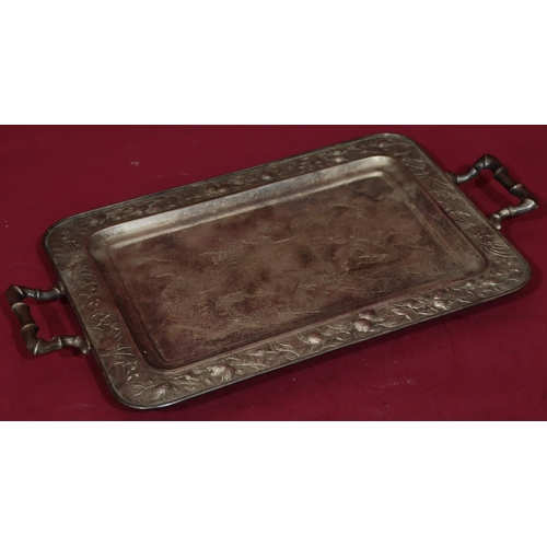 321 - An Oriental silver coloured metal 2-handled tray with bamboo shaped handles and embossed floral and ... 