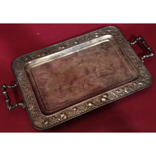 321 - An Oriental silver coloured metal 2-handled tray with bamboo shaped handles and embossed floral and ... 