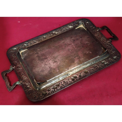 321 - An Oriental silver coloured metal 2-handled tray with bamboo shaped handles and embossed floral and ... 