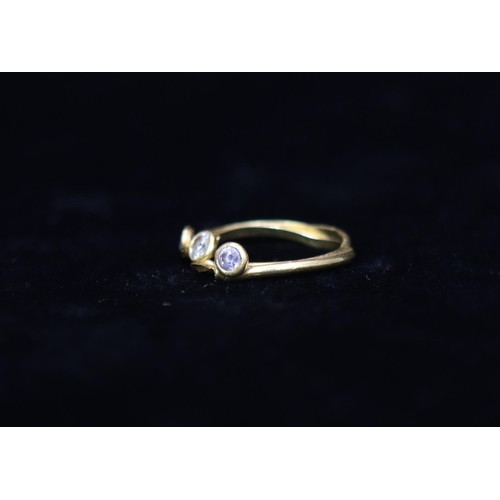 335 - An 18ct gold ladies' 3-stone ring set with clear stones, Size M, overall weight 2 grams gross