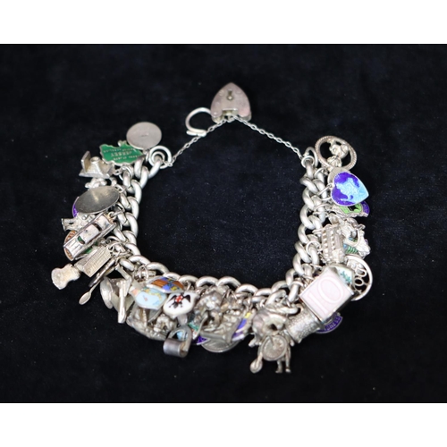 345 - A silver linked bracelet with padlock clasp, mounted with approx. 48 silver coloured metal and other... 