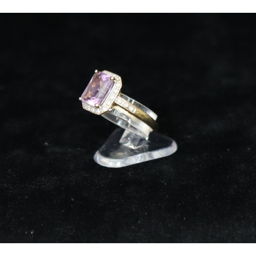 359 - A 9ct gold ladies' ring set with centre purple stone surrounded by small diamond chips, Size M/N, 3 ... 