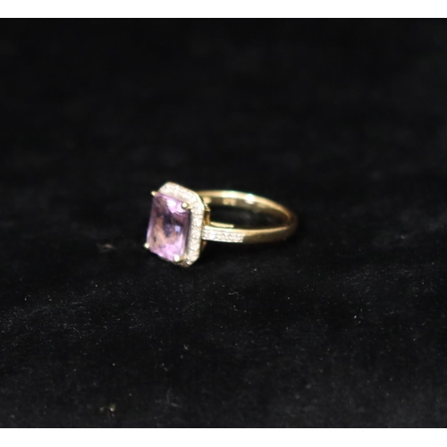 359 - A 9ct gold ladies' ring set with centre purple stone surrounded by small diamond chips, Size M/N, 3 ... 