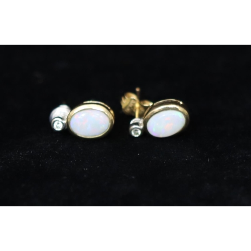 361 - A pair of 18ct gold oval opal earrings mounted with small diamonds, 1.9 grams gross