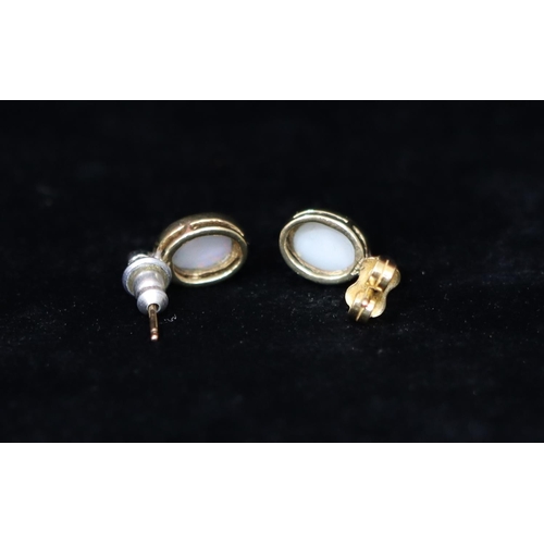 361 - A pair of 18ct gold oval opal earrings mounted with small diamonds, 1.9 grams gross