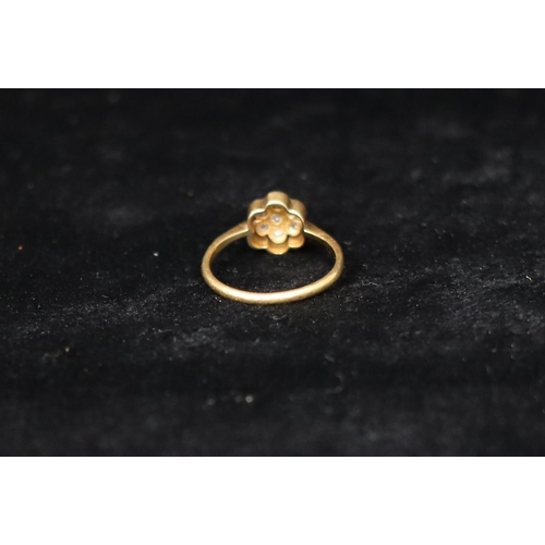 379 - An 18ct gold floral cluster ring set with 7 diamonds, Size M/N, 2.2 grams