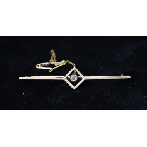 385 - A gold bar brooch set with rectangular centre, inset with small solitaire diamonds, 4 grams