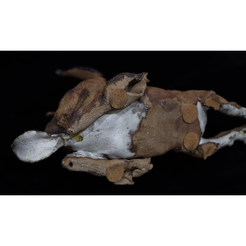 39 - A Studio earthenware figure of a hare with glass eyes (tail restored)