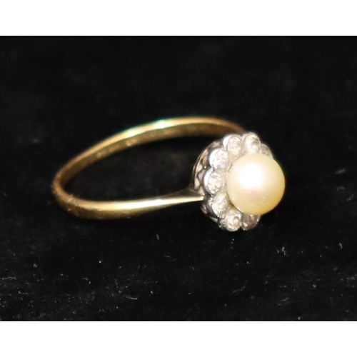 391 - An 18ct gold cluster ring set with centre pearl, surrounded by 10 diamonds, Size R, 2.6 grams