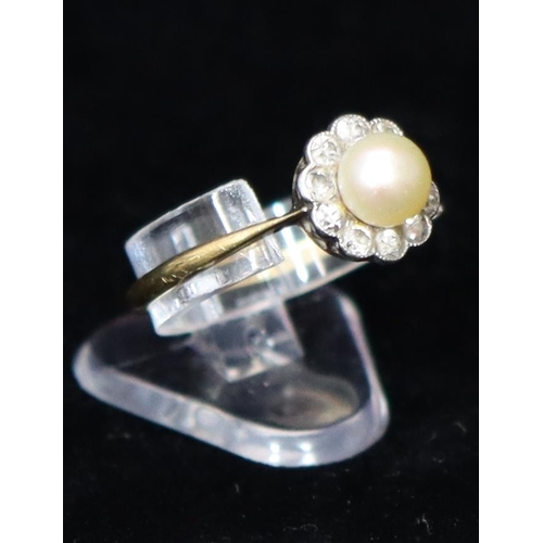 391 - An 18ct gold cluster ring set with centre pearl, surrounded by 10 diamonds, Size R, 2.6 grams