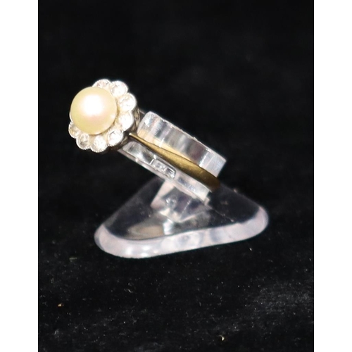 391 - An 18ct gold cluster ring set with centre pearl, surrounded by 10 diamonds, Size R, 2.6 grams