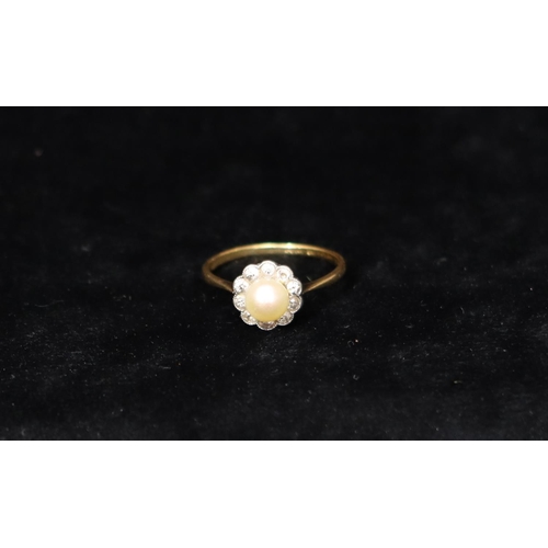 391 - An 18ct gold cluster ring set with centre pearl, surrounded by 10 diamonds, Size R, 2.6 grams