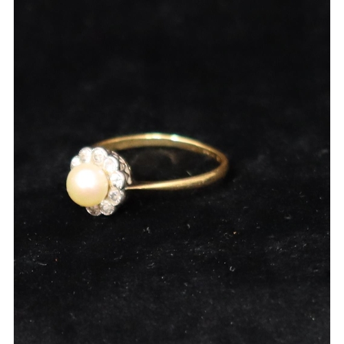 391 - An 18ct gold cluster ring set with centre pearl, surrounded by 10 diamonds, Size R, 2.6 grams