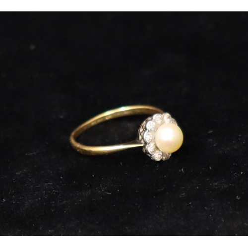 391 - An 18ct gold cluster ring set with centre pearl, surrounded by 10 diamonds, Size R, 2.6 grams