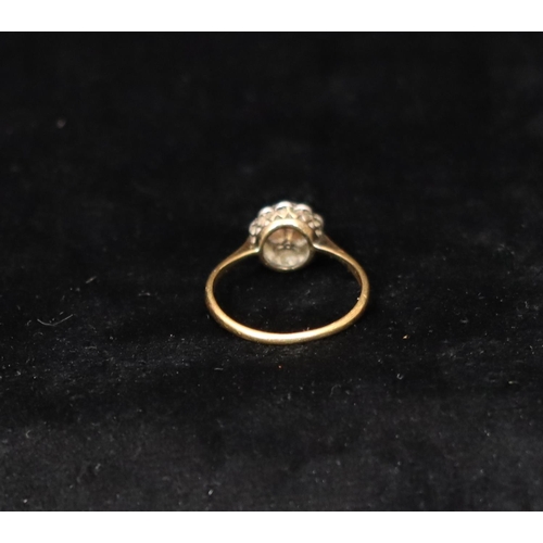 391 - An 18ct gold cluster ring set with centre pearl, surrounded by 10 diamonds, Size R, 2.6 grams