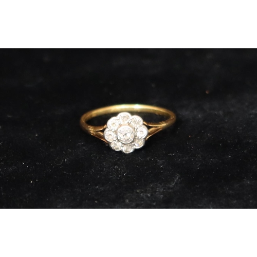 392 - An 18ct gold cluster ring set with centre diamond, surrounded by 8 smaller diamonds, Size R, 2.5 gra... 