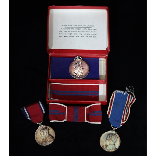 403 - A George V and Queen Mary Silver Jubilee medal, A George VI and Queen Elizabeth medal and an Elizabe... 