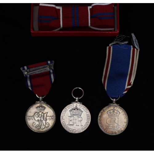 403 - A George V and Queen Mary Silver Jubilee medal, A George VI and Queen Elizabeth medal and an Elizabe... 