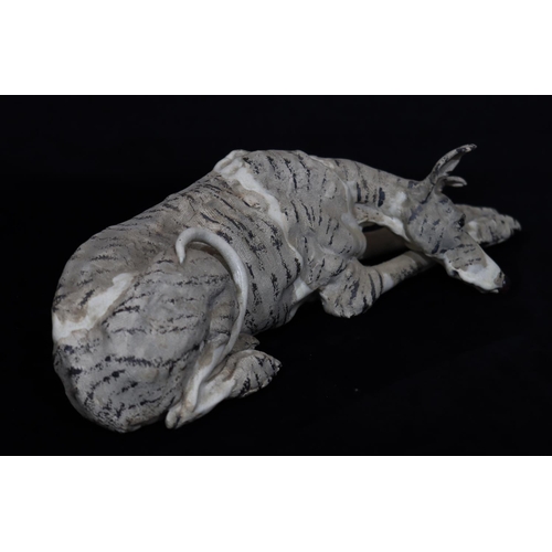 43 - A Studio glazed earthenware model of a resting Greyhound with embossed monogram, 50cm long